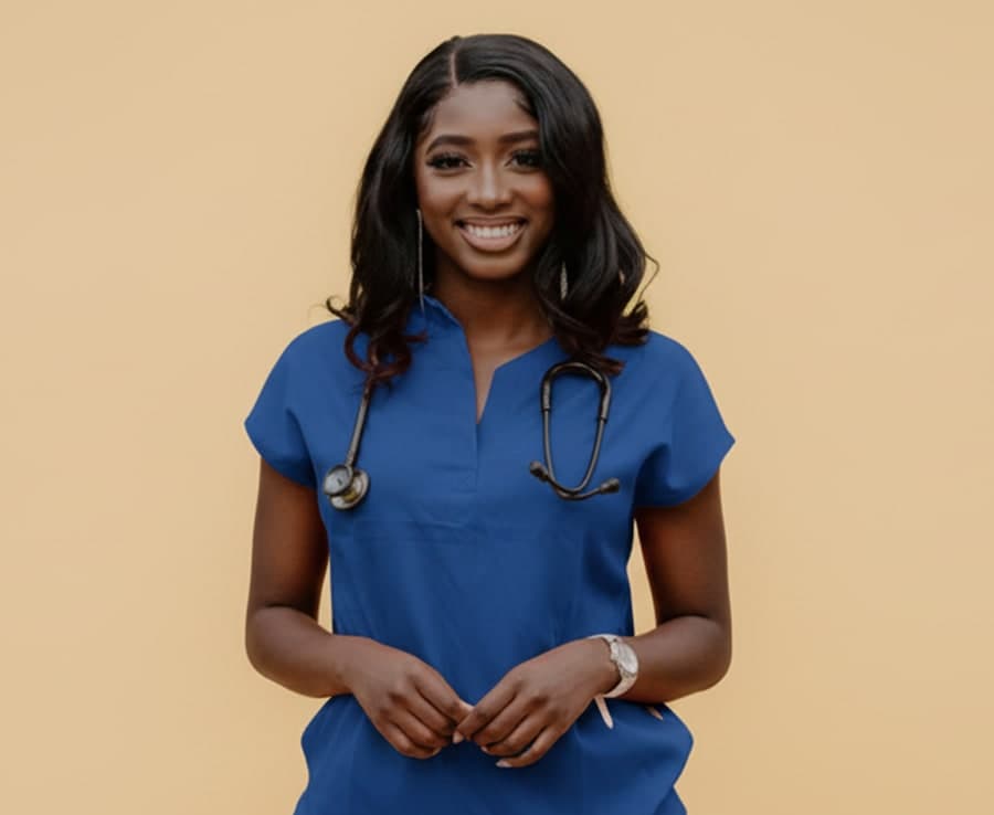 Oluwatosin in navy scrubs with stethoscope